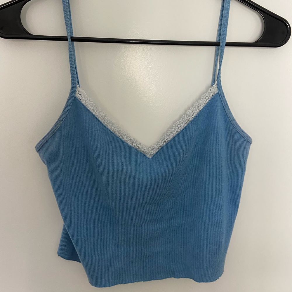 Blue brandy Melville tank with white lace trim.